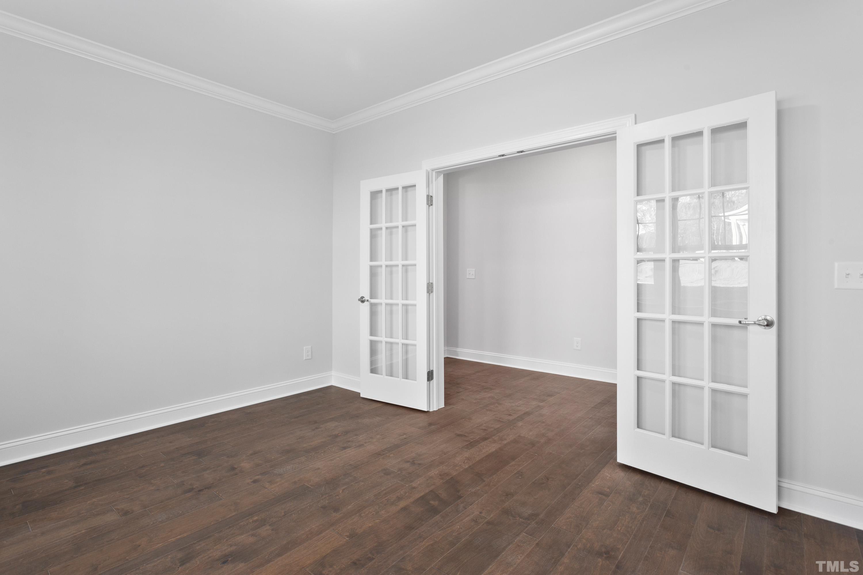 137 English Violet Lane Raleigh, NC 27610 - Photo 7 of 27 an empty room with wooden floor and windows