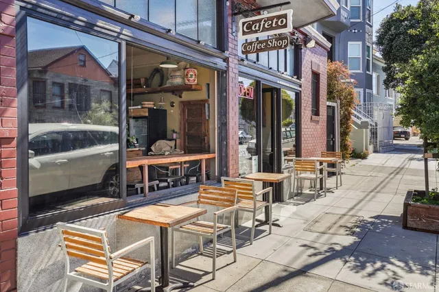 a view of a patio with a table and chairs and floor to ceiling window