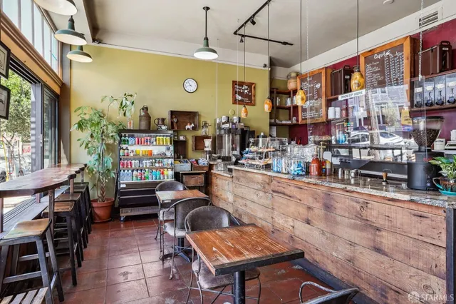 a kitchen filled with stainless steel appliances kitchen island granite countertop a table chairs in it and a window