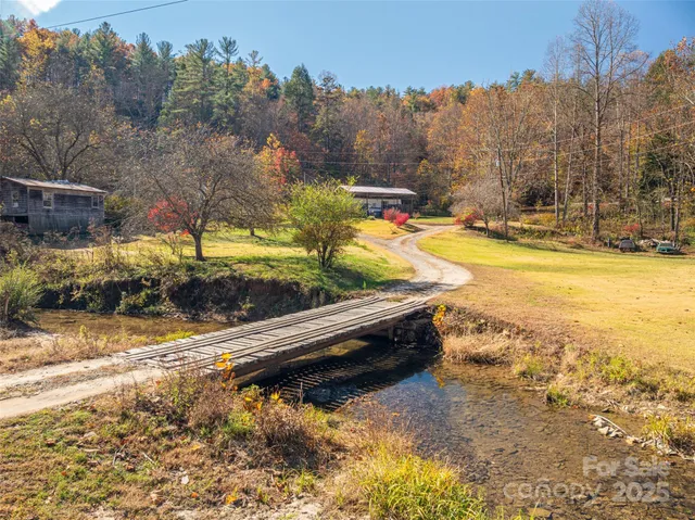 a view of swimming pool with a yard and trees