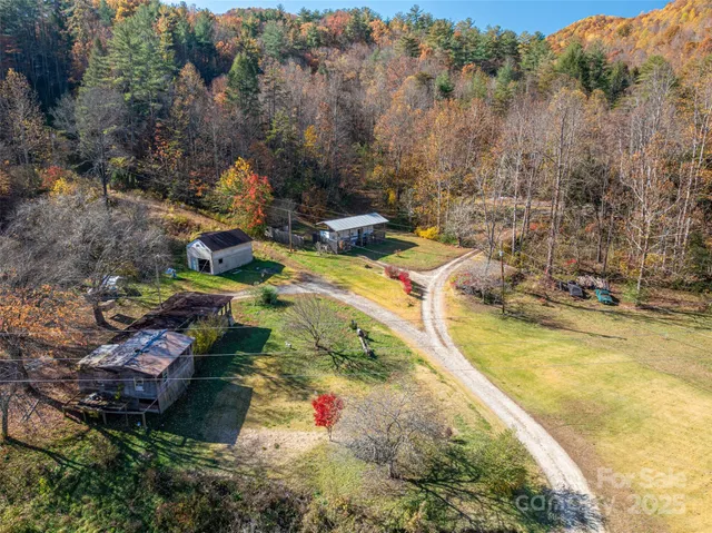 a view of swimming pool with seating area and trees around