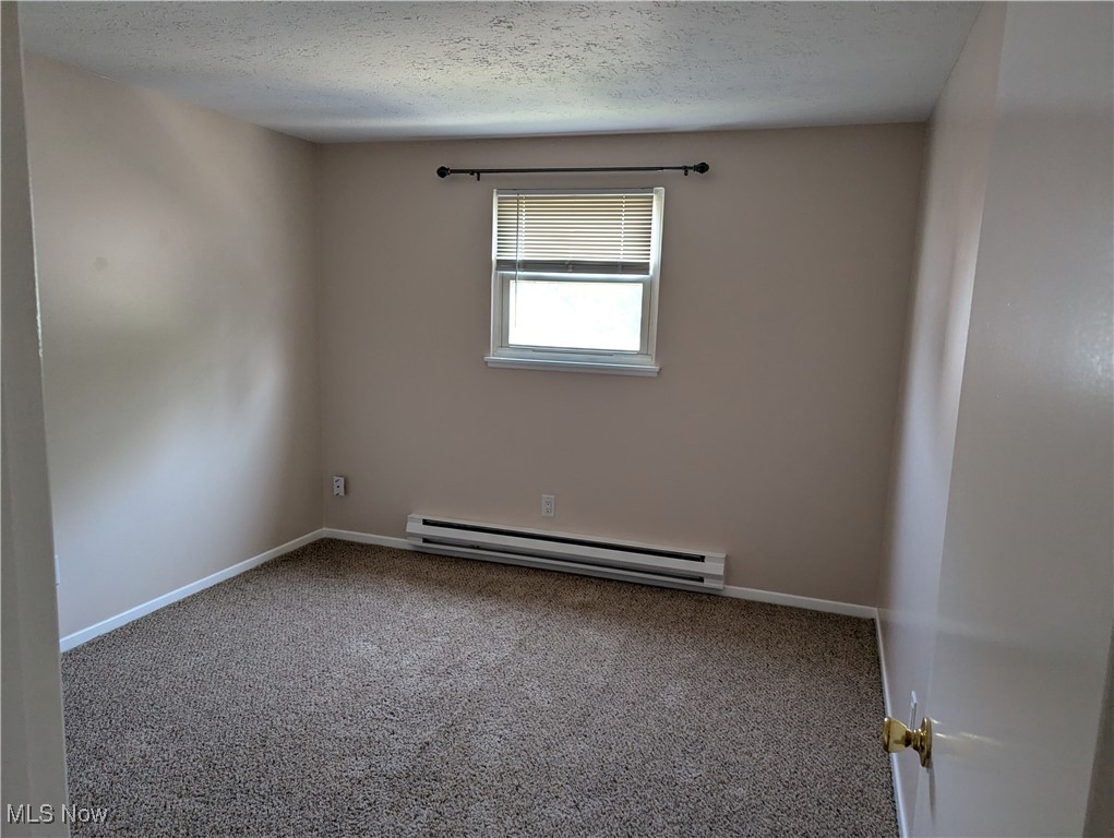 35286 Drake Street North Ridgeville, OH 44039 - Photo 21 of 24 Unfurnished 3rd bedroom with carpet flooring, baseboard heating, and a textured ceiling