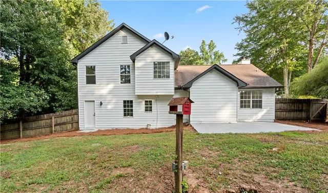 a view of house with backyard and garden