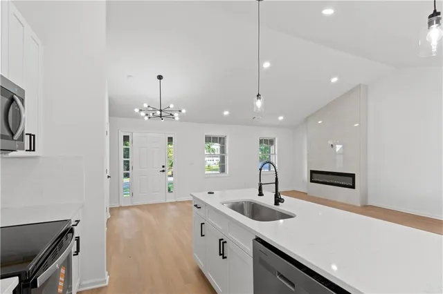 a kitchen with stainless steel appliances a stove sink and a refrigerator