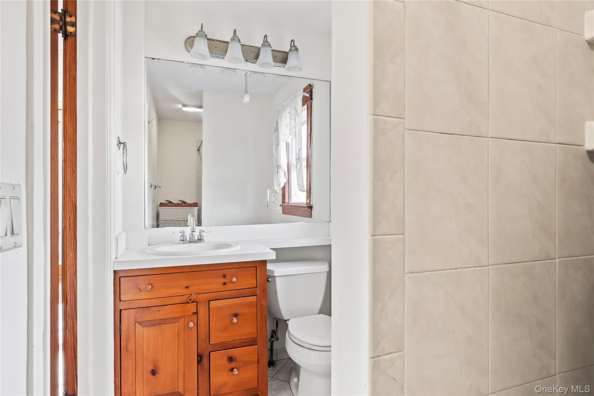47 Prairie Avenue Suffern, NY 10901 - Photo 16 of 45 a bathroom with a granite countertop toilet sink and mirror