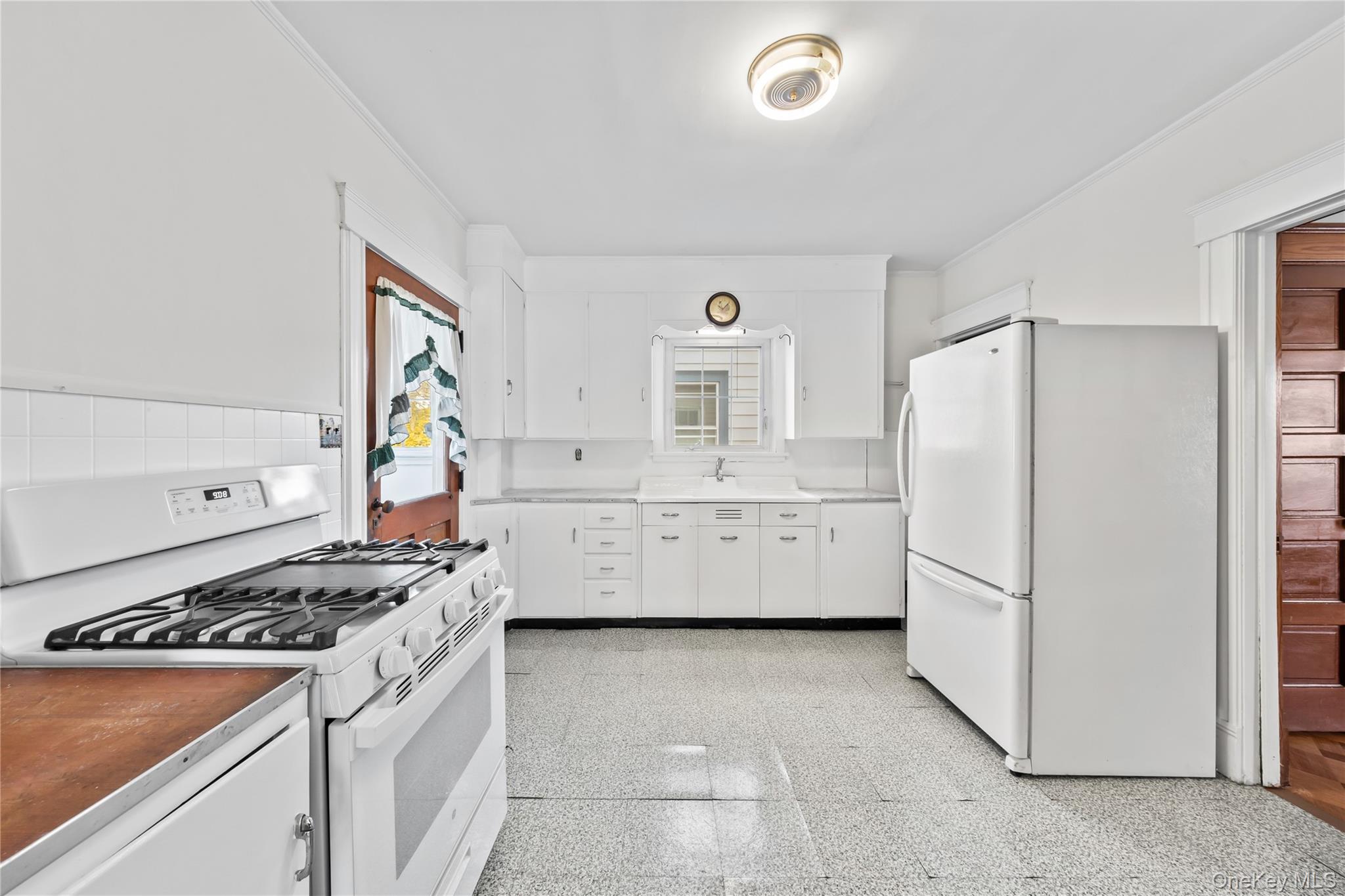 47 Prairie Avenue Suffern, NY 10901 - Photo 10 of 45 a kitchen with a refrigerator a stove a microwave and cabinets