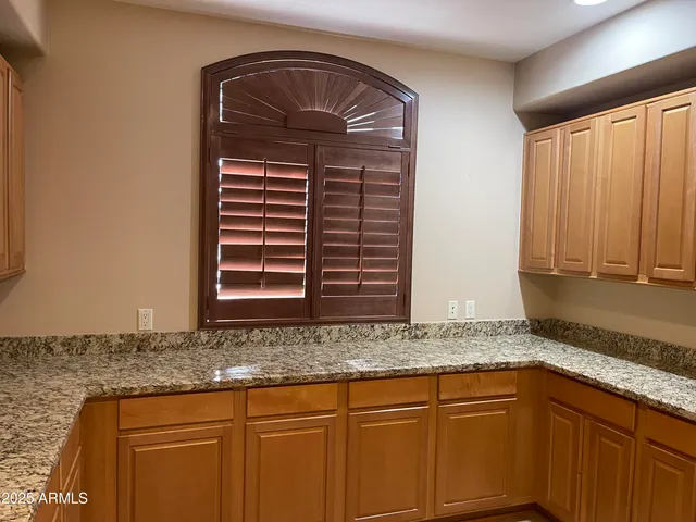 a kitchen with granite countertop cabinets and sink