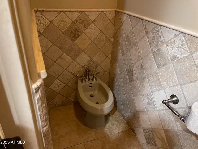 a bathroom with a toilet and a shower curtain
