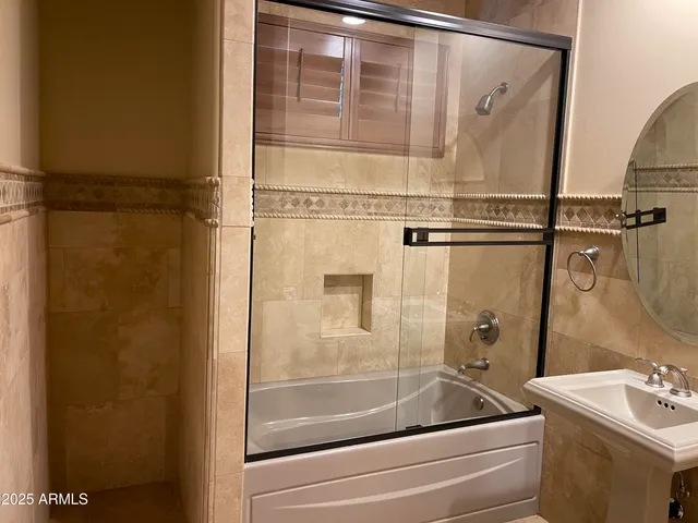a bathroom with a bathtub and a shower