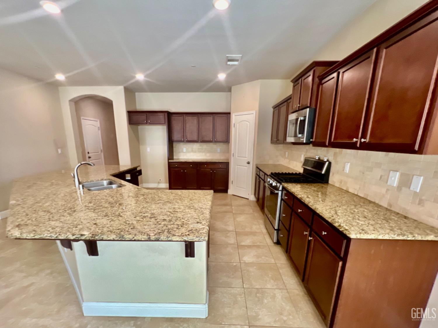 Undisclosed Address Bakersfield, CA 93311 - Photo 14 of 63 a kitchen with stainless steel appliances granite countertop a sink stove and refrigerator