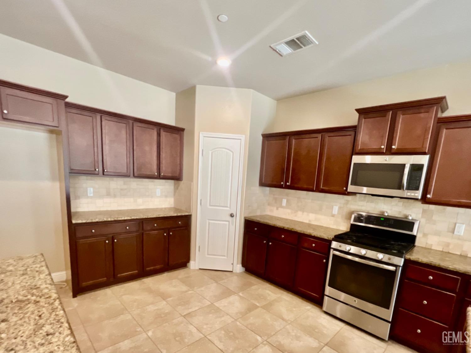 Undisclosed Address Bakersfield, CA 93311 - Photo 15 of 63 a kitchen with stainless steel appliances granite countertop a refrigerator and a stove top oven