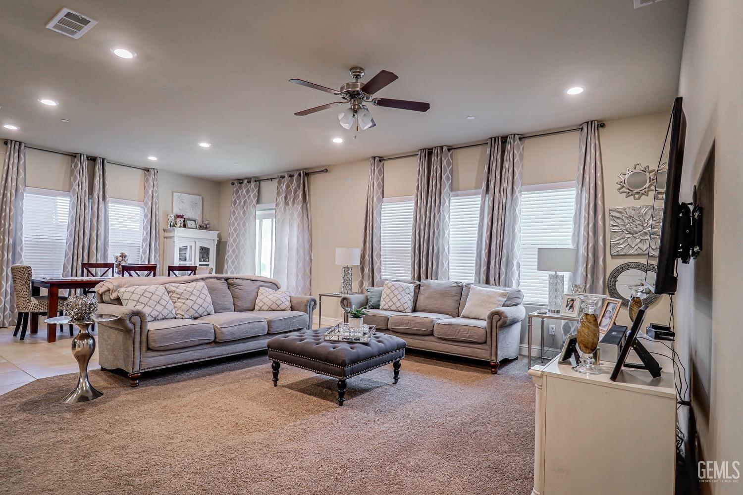 Undisclosed Address Bakersfield, CA 93311 - Photo 17 of 63 a living room with furniture ceiling fan and a large window