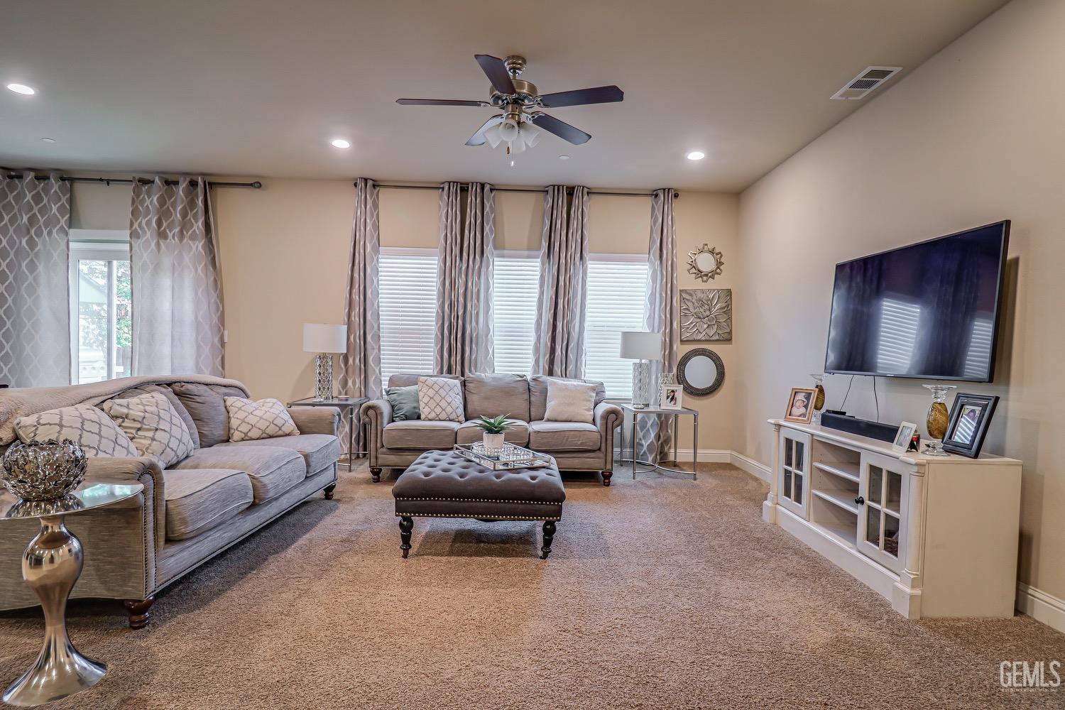 Undisclosed Address Bakersfield, CA 93311 - Photo 18 of 63 a living room with furniture and a flat screen tv