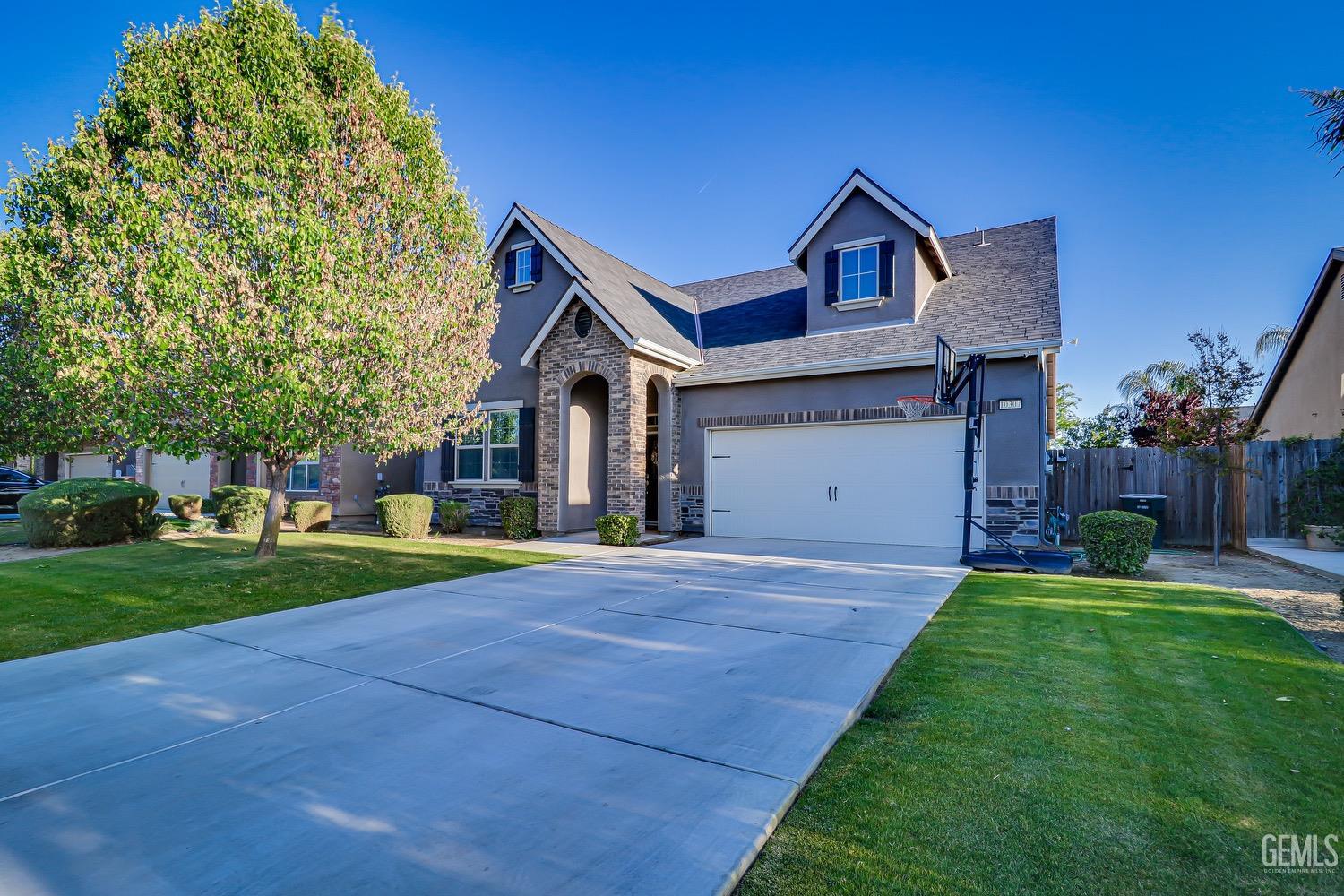 Undisclosed Address Bakersfield, CA 93311 - Photo 2 of 63 a front view of a house with a yard and garage
