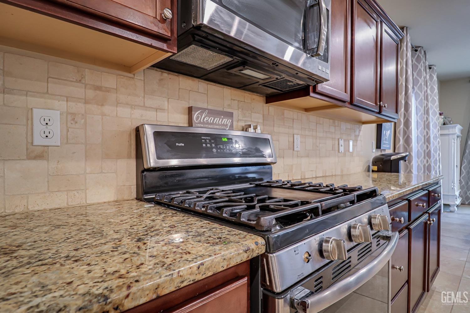 Undisclosed Address Bakersfield, CA 93311 - Photo 23 of 63 a stove top oven sitting inside of a kitchen