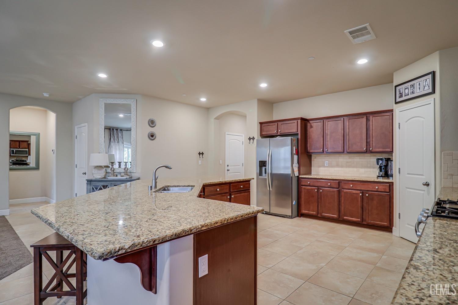 Undisclosed Address Bakersfield, CA 93311 - Photo 24 of 63 a kitchen with refrigerator and cabinets
