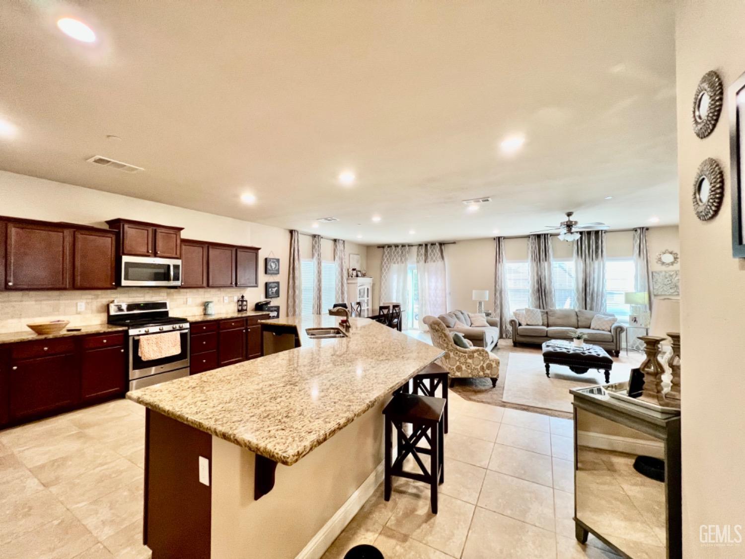 Undisclosed Address Bakersfield, CA 93311 - Photo 32 of 63 a large kitchen with a table and chairs in it