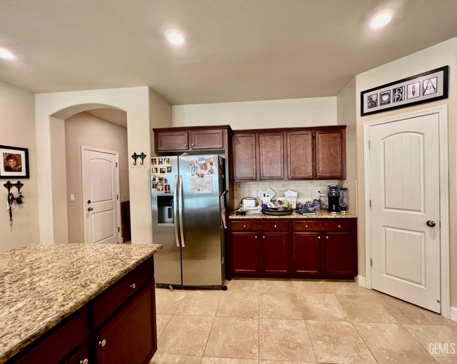 Undisclosed Address Bakersfield, CA 93311 - Photo 33 of 63 a kitchen with granite countertop a refrigerator and a sink