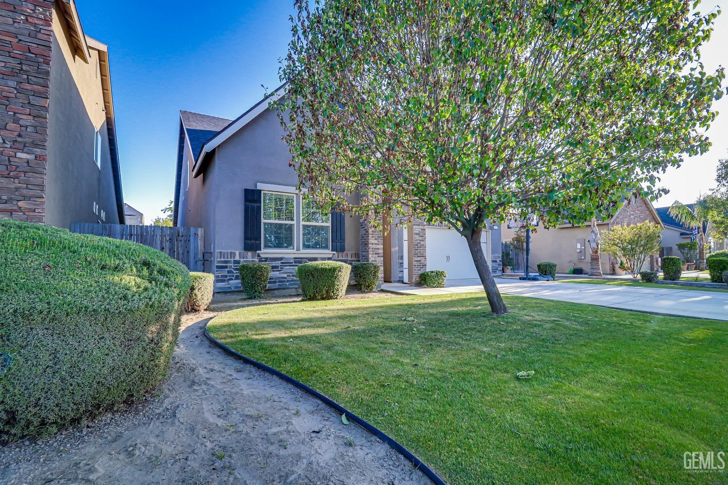 Undisclosed Address Bakersfield, CA 93311 - Photo 4 of 63 a view of a house with backyard and a tree