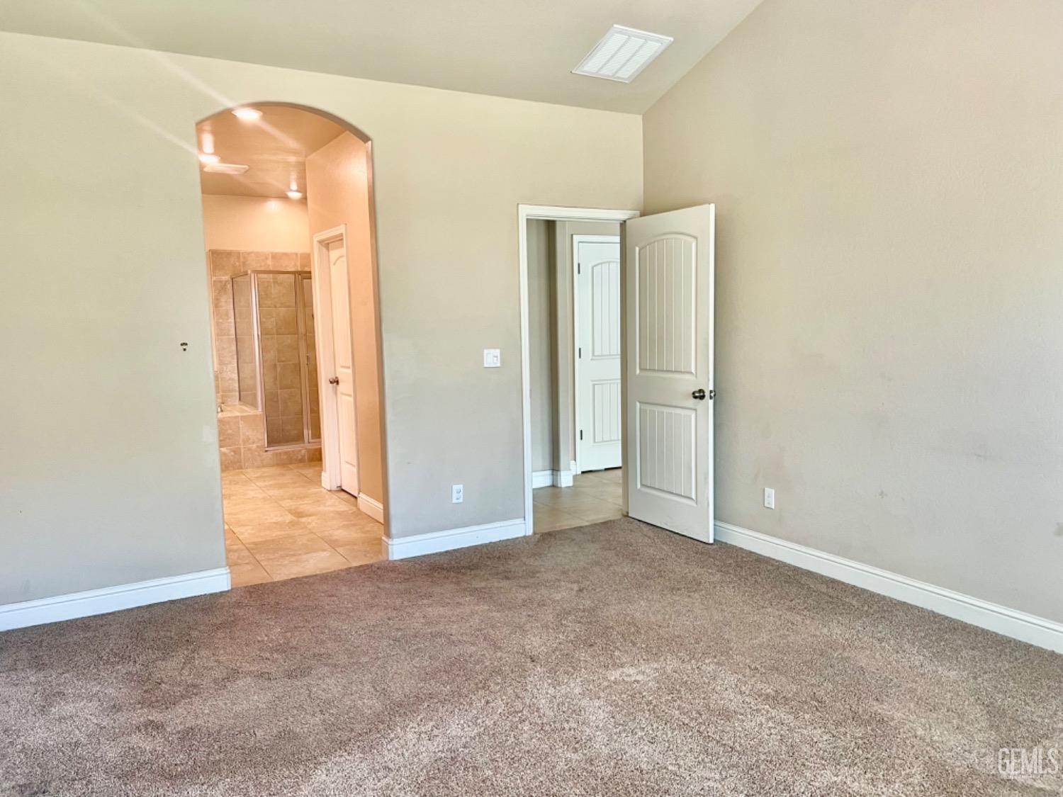 Undisclosed Address Bakersfield, CA 93311 - Photo 42 of 63 an empty room with closet and mirror