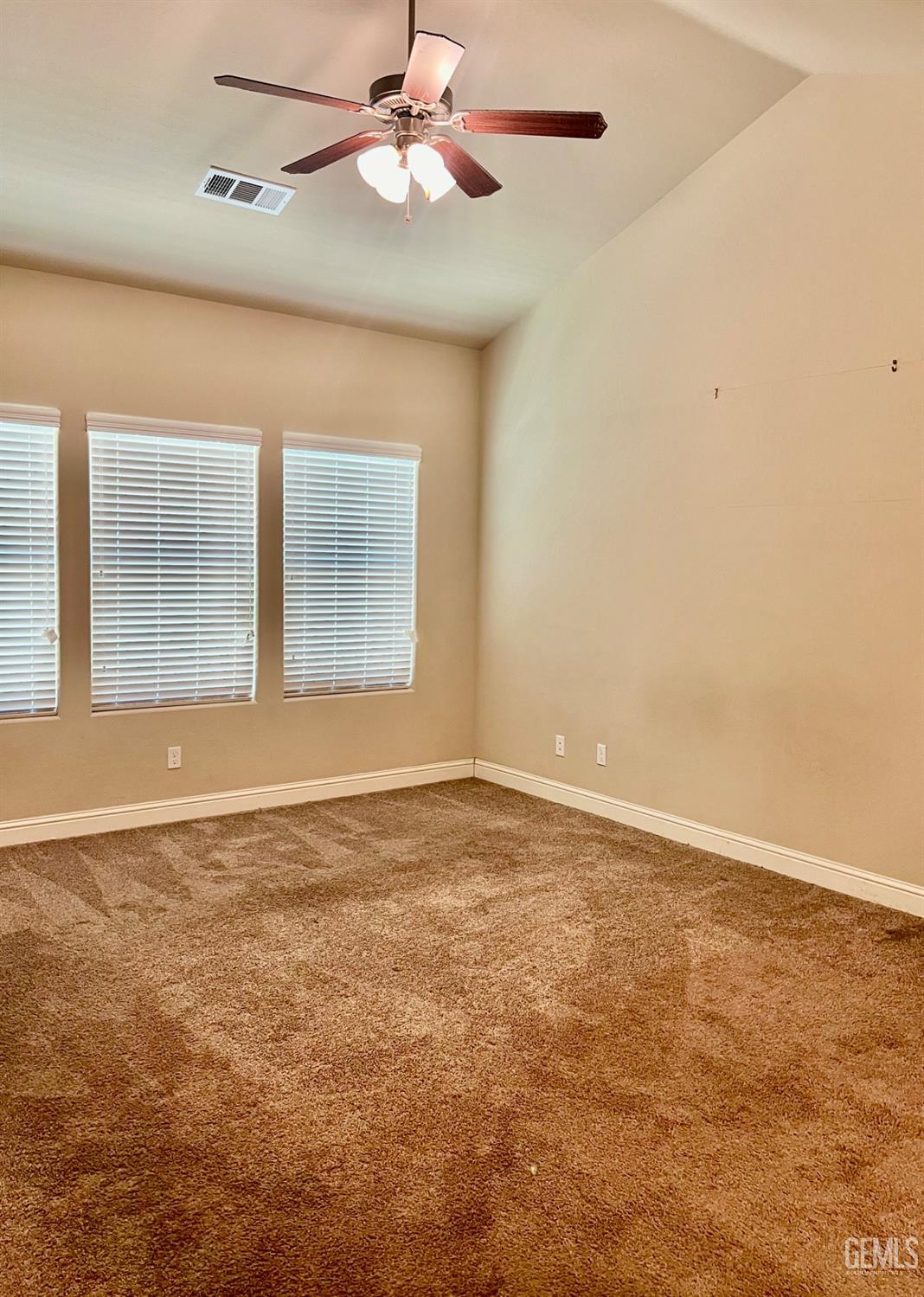 Undisclosed Address Bakersfield, CA 93311 - Photo 43 of 63 an empty room with chandelier fan and windows