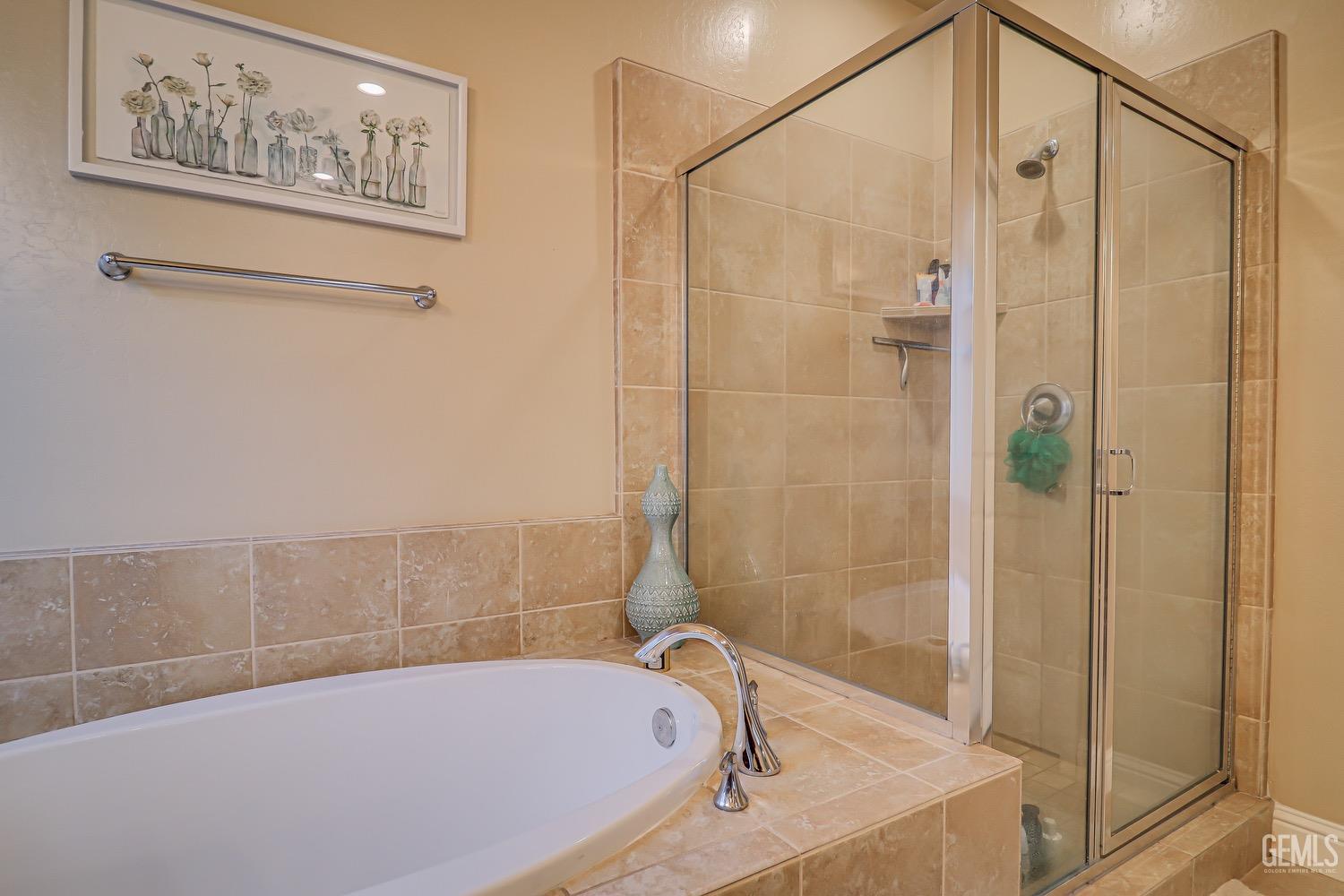 Undisclosed Address Bakersfield, CA 93311 - Photo 45 of 63 a bathroom with a bathtub and a shower