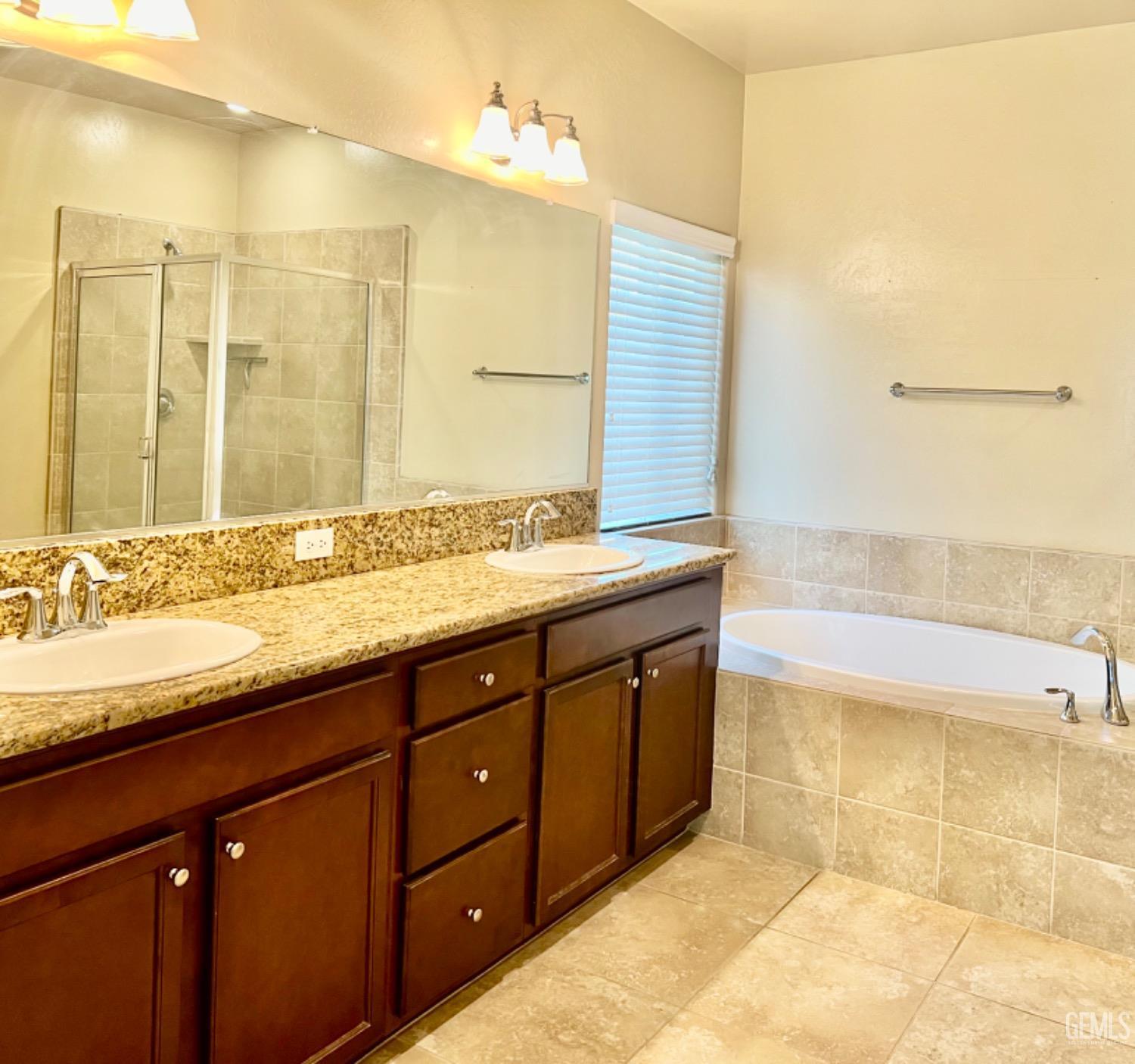 Undisclosed Address Bakersfield, CA 93311 - Photo 46 of 63 a bathroom with a granite countertop sink and a bathtub