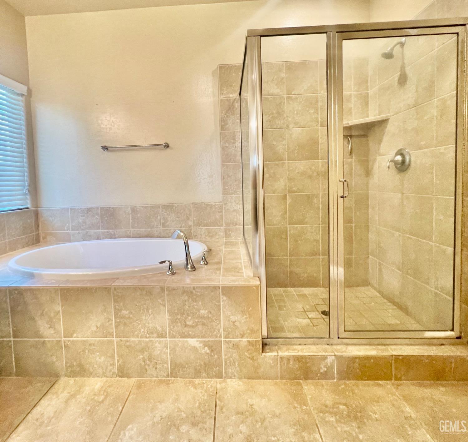Undisclosed Address Bakersfield, CA 93311 - Photo 49 of 63 a bathroom with a bathtub and a shower
