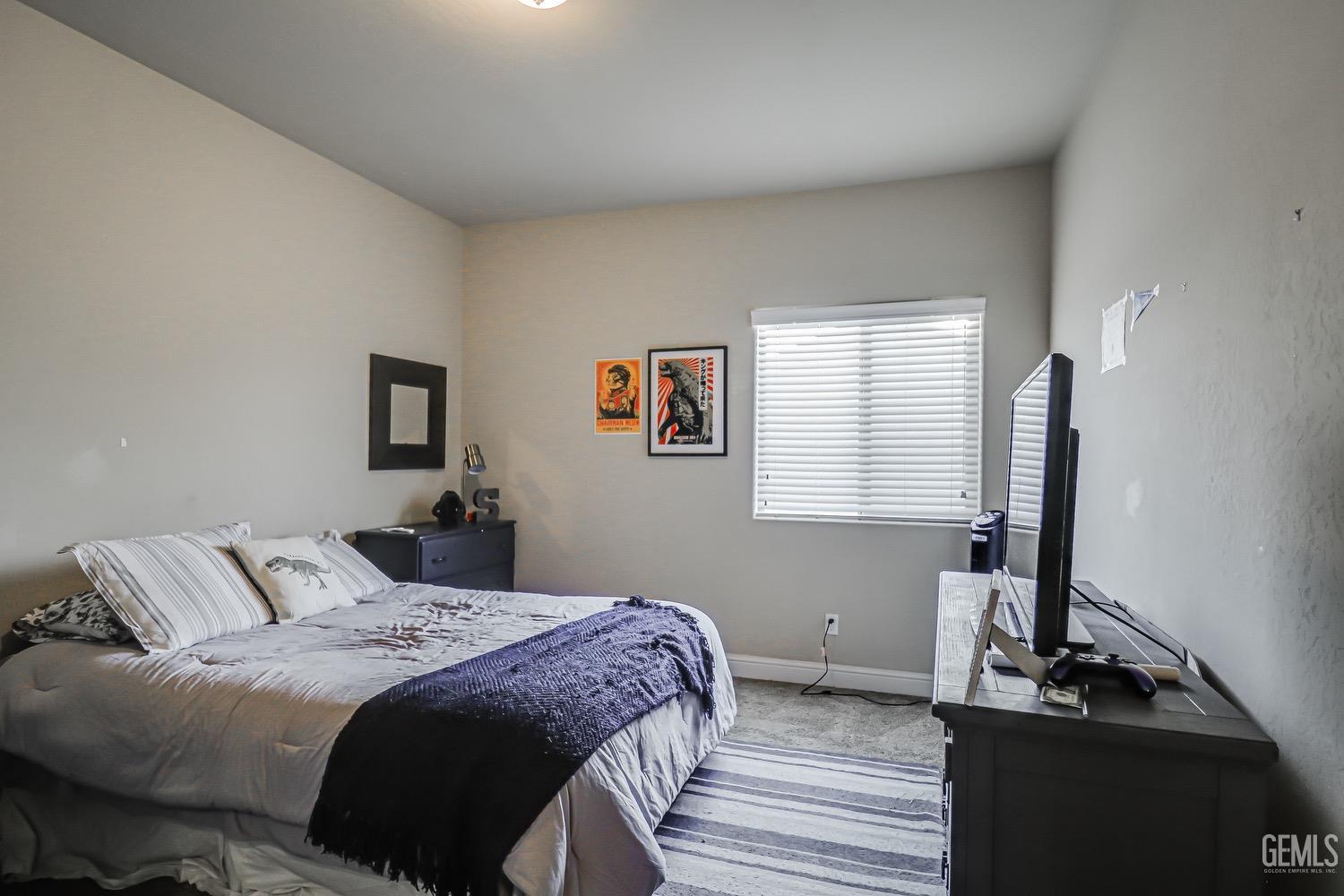 Undisclosed Address Bakersfield, CA 93311 - Photo 54 of 63 a bedroom with a bed and a window