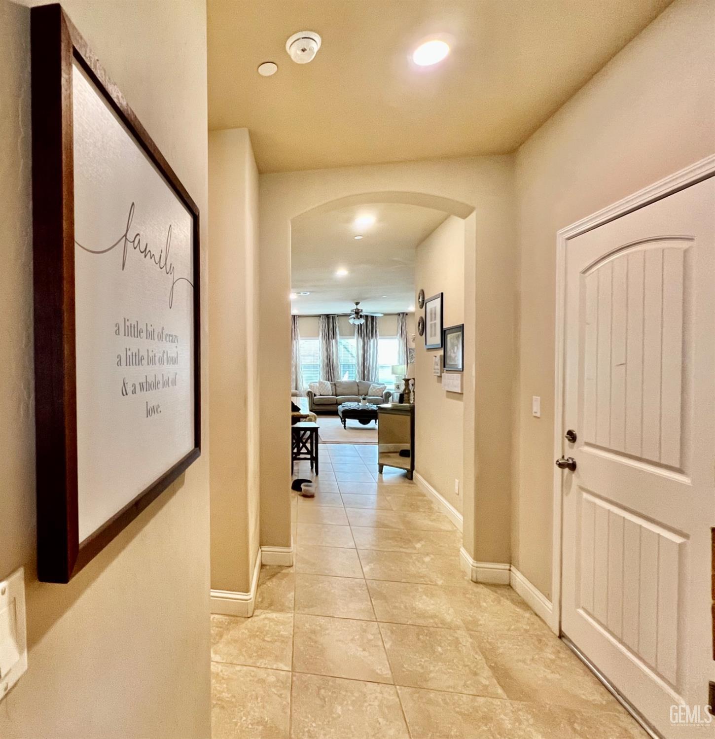 Undisclosed Address Bakersfield, CA 93311 - Photo 6 of 63 a view of a hallway with dining area and chandelier