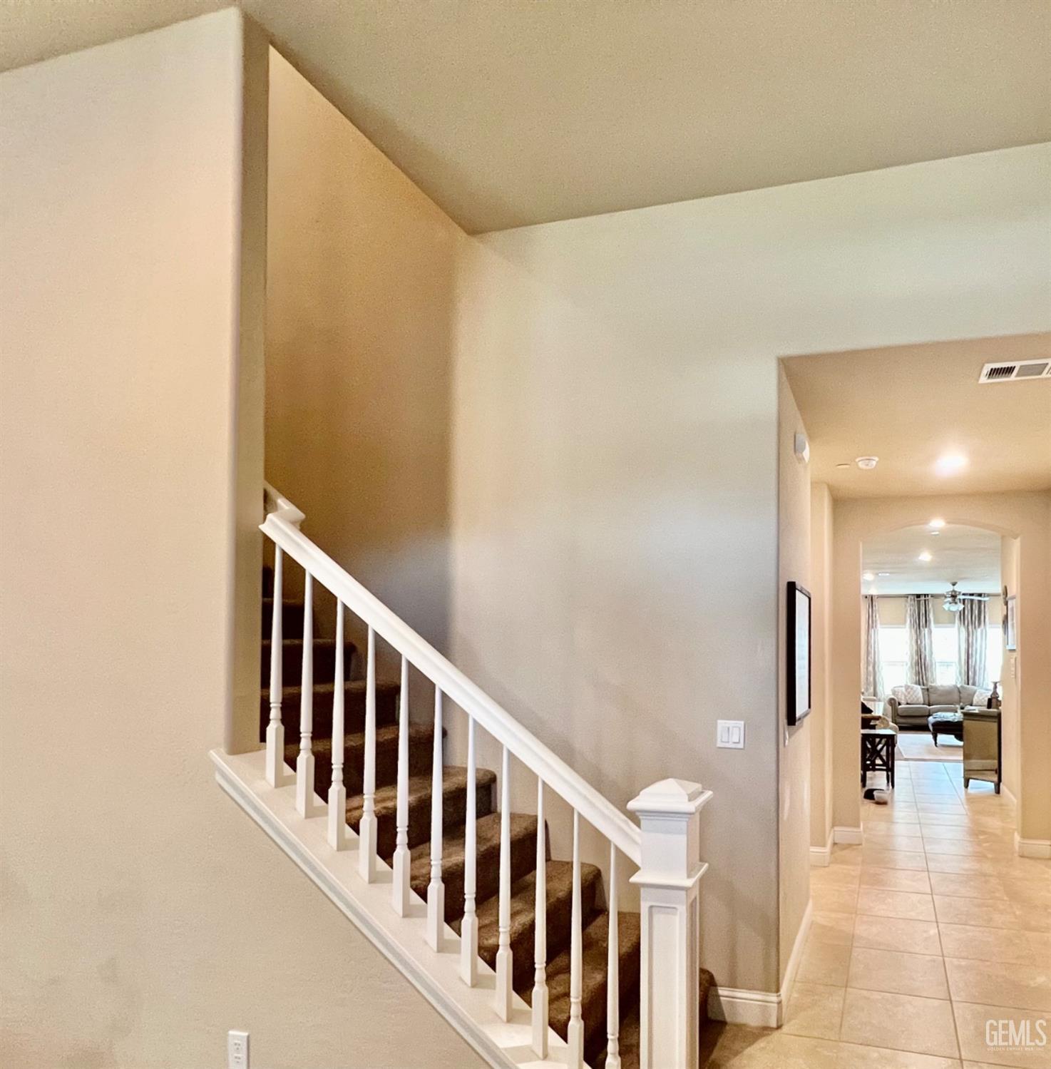 Undisclosed Address Bakersfield, CA 93311 - Photo 8 of 63 a view of a hallway with a dining table & chairs