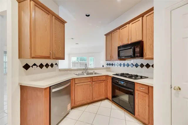 a kitchen with stainless steel appliances granite countertop a sink and a stove