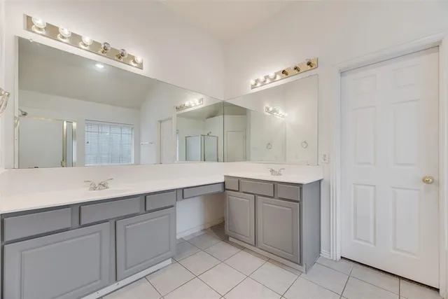 a bathroom with a sink vanity and mirror