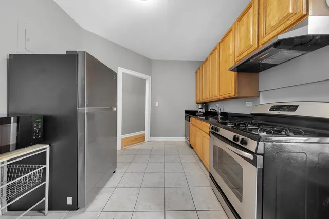a kitchen with granite countertop a sink stove and cabinets