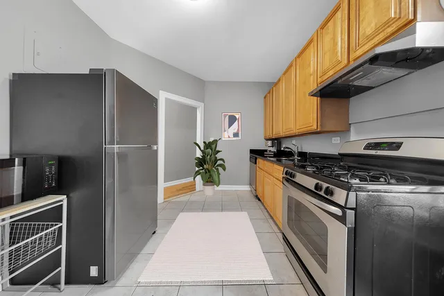 a bedroom with a bed and a view of living room