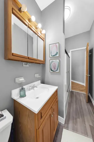 a kitchen with granite countertop a stove a sink a dining table and chairs