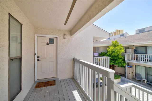 a view of a balcony with wooden floor