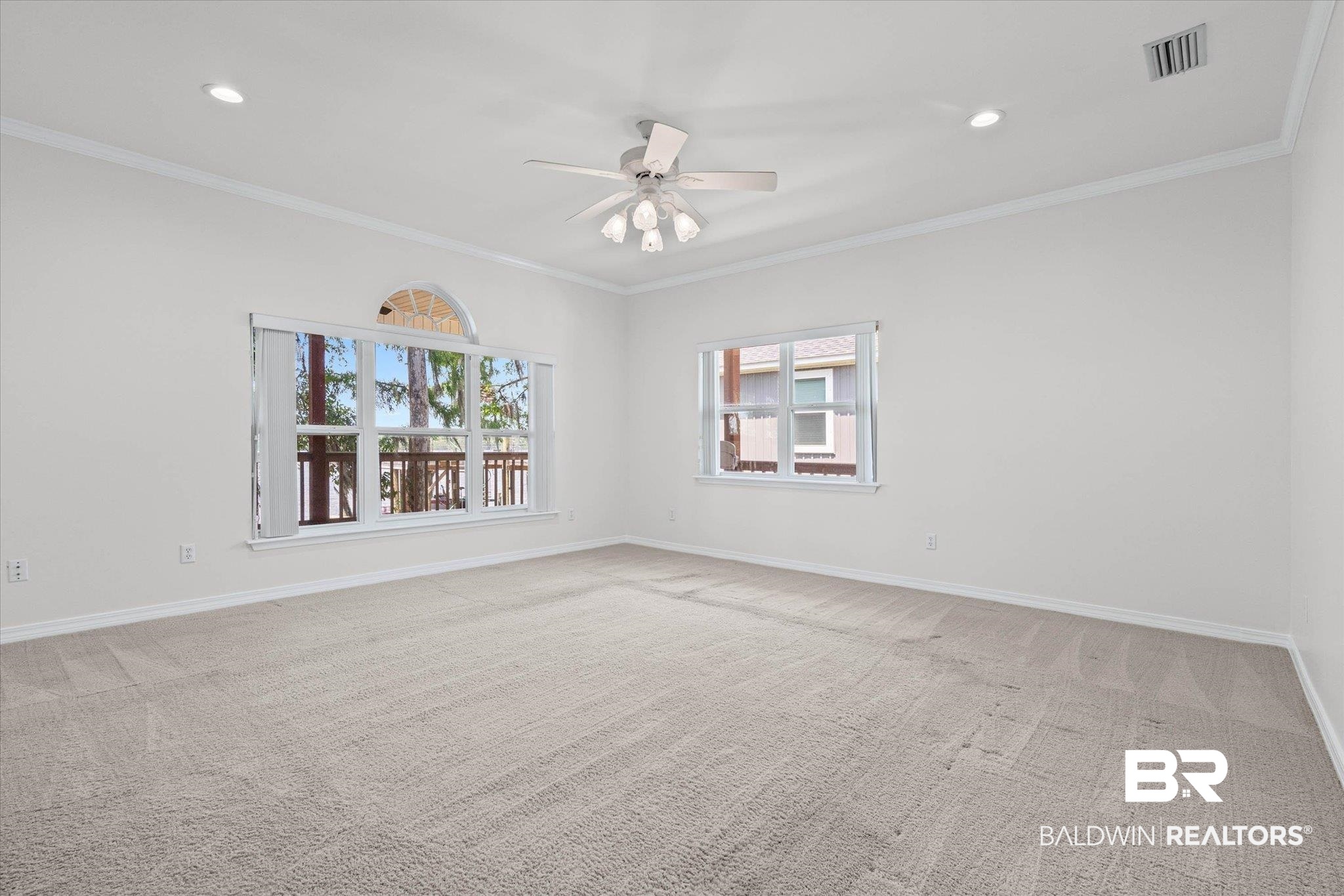41923 Bayou Road Bay Minette, AL 36507 - Photo 2 of 35 Spacious room featuring light-toned carpeting and multiple windows