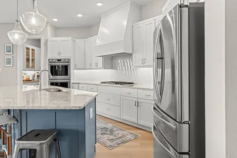 a large kitchen with a table and chairs