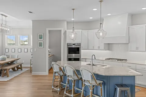 a kitchen with stainless steel appliances granite countertop a refrigerator and a stove top oven