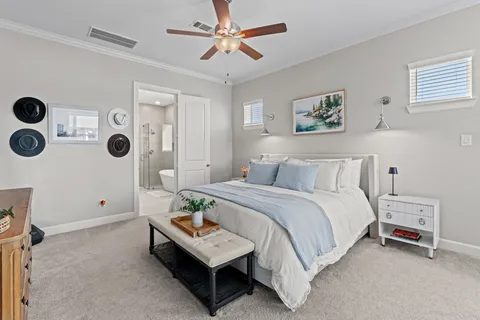 a bedroom with a bed a flat screen tv and a dresser