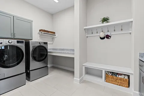 a spacious bathroom with a double vanity sink mirror and bathtub