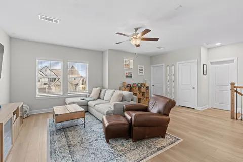 a utility room with dryer washer and a view of living room