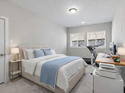 a bedroom with furniture and a window