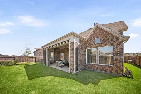 a view of a house with a yard and pathway