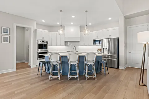 a living room with furniture kitchen view and a dining table