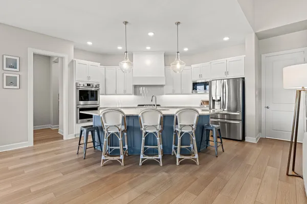 a bathroom with a bathtub sink mirror vanity and toilet