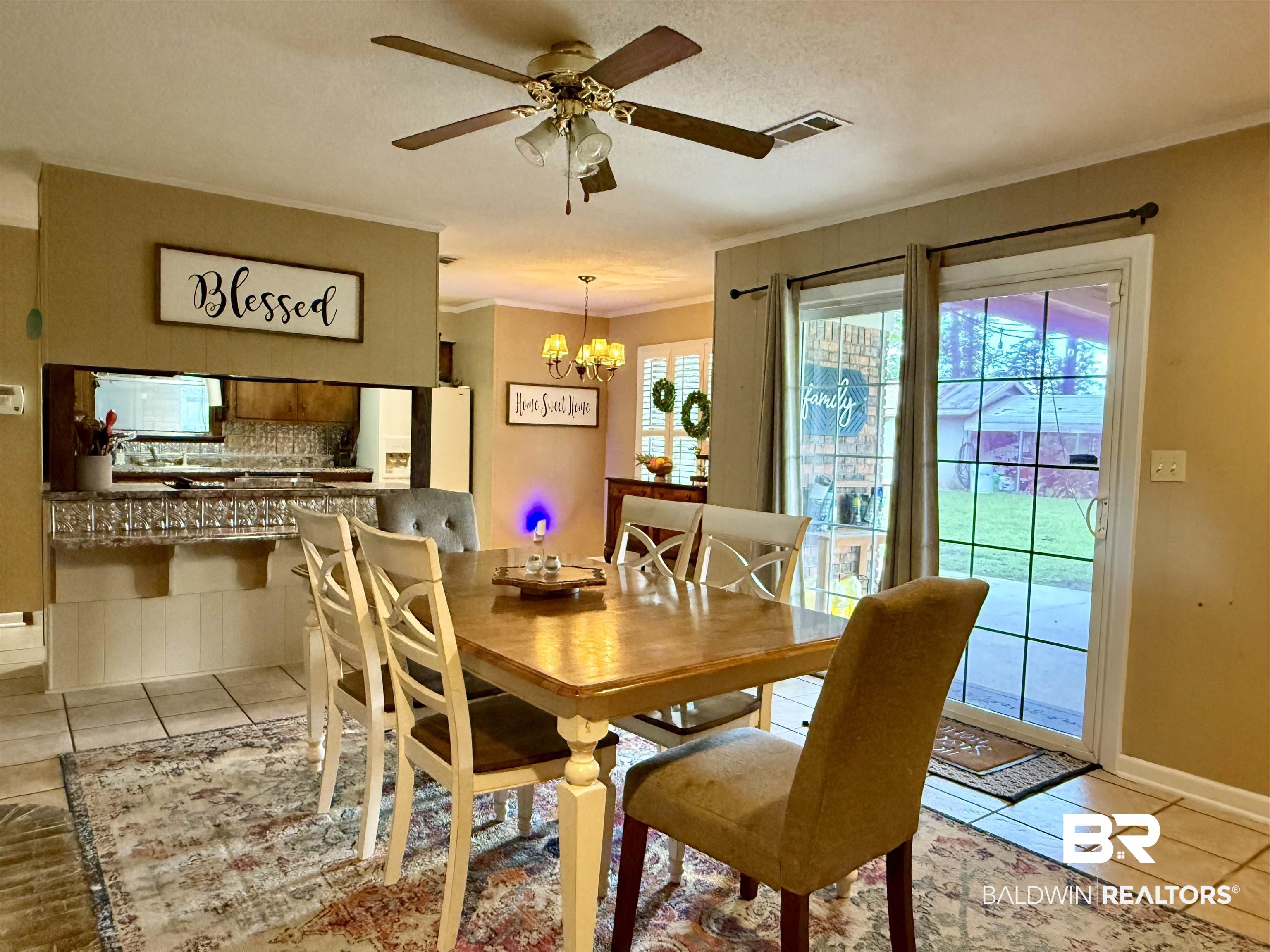 5971 Appleton Road Brewton, AL 36426 - Photo 5 of 23 Dining room with light tile patterned flooring, a chandelier, ceiling fan, and crown molding