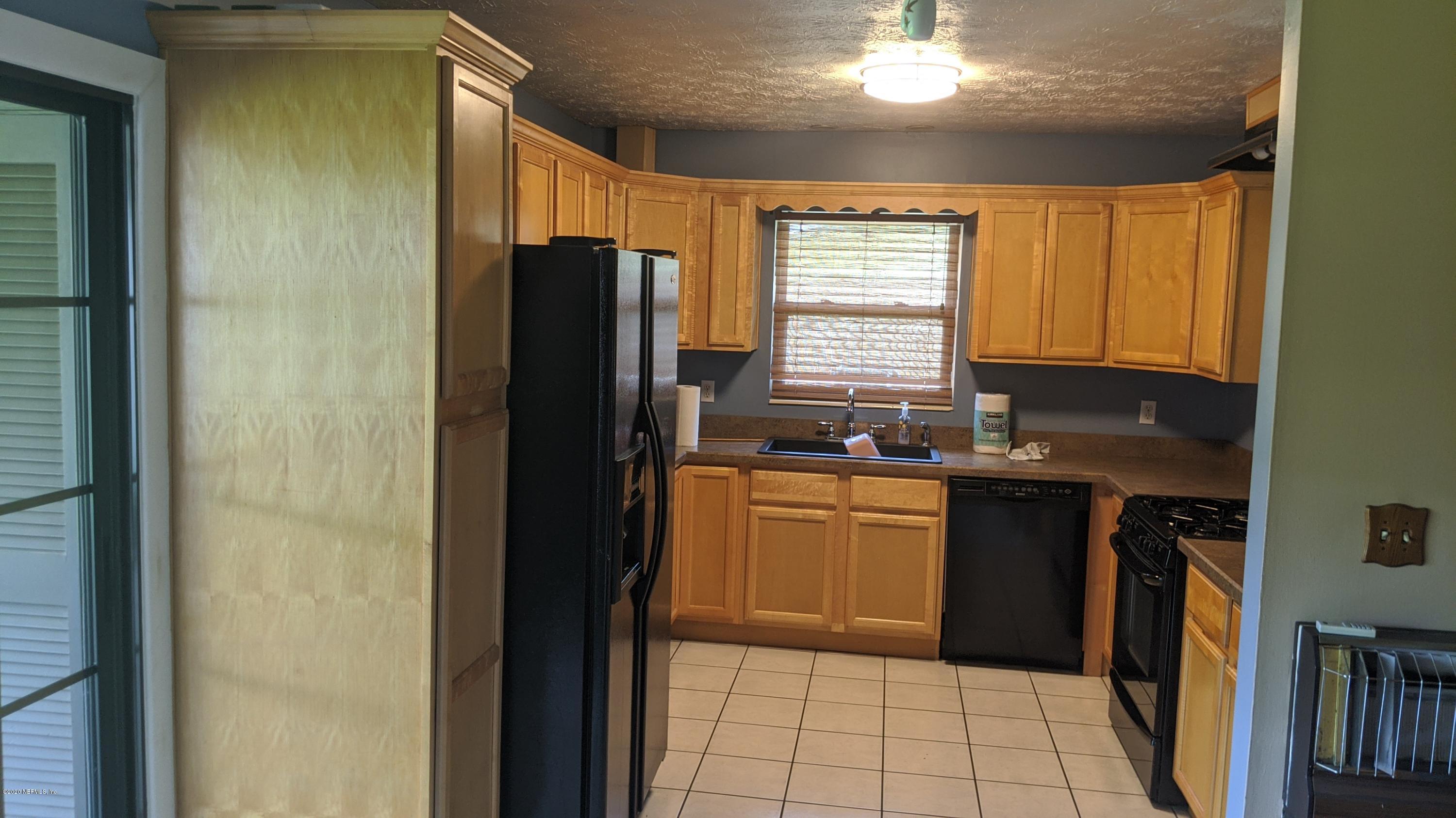 5712 Beney Road Jacksonville, FL 32207 - Photo 3 of 11 a kitchen with granite countertop a refrigerator and a sink