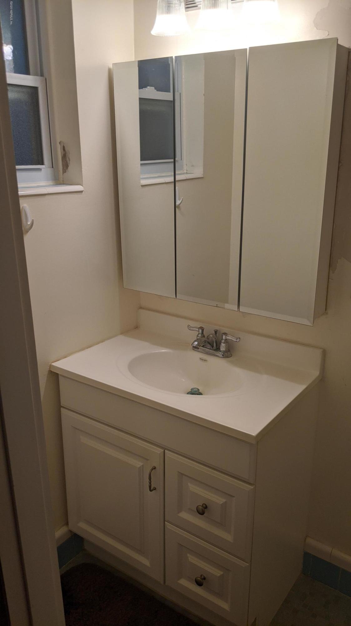 5712 Beney Road Jacksonville, FL 32207 - Photo 7 of 11 a bathroom with a sink and mirror